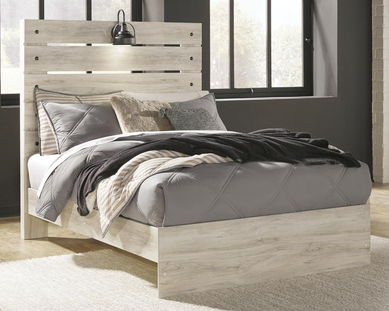 Ashley Furniture Cambeck Bed with a wooden frame and upholstered headboard, shown in a modern bedroom setting.