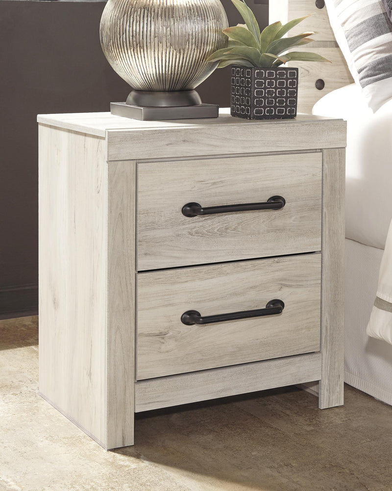 Ashley Furniture Cambeck nightstand with a sleek wood finish and modern design, featuring a single drawer and open storage space.