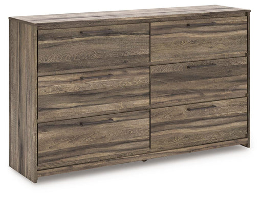Ashley Furniture Elbrim Dresser with multiple drawers, shown from an angled view, in a modern bedroom setting.