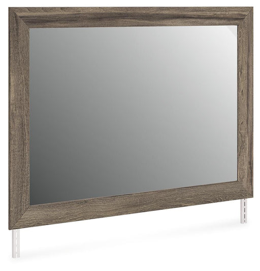 Ashley Furniture Elbrim bedroom mirror with a sleek rectangular design, shown from an angled side view.