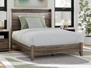 Ashley Furniture Elbrim Bed with a wooden frame, featuring a classic design and a warm finish, shown in a bedroom setting.