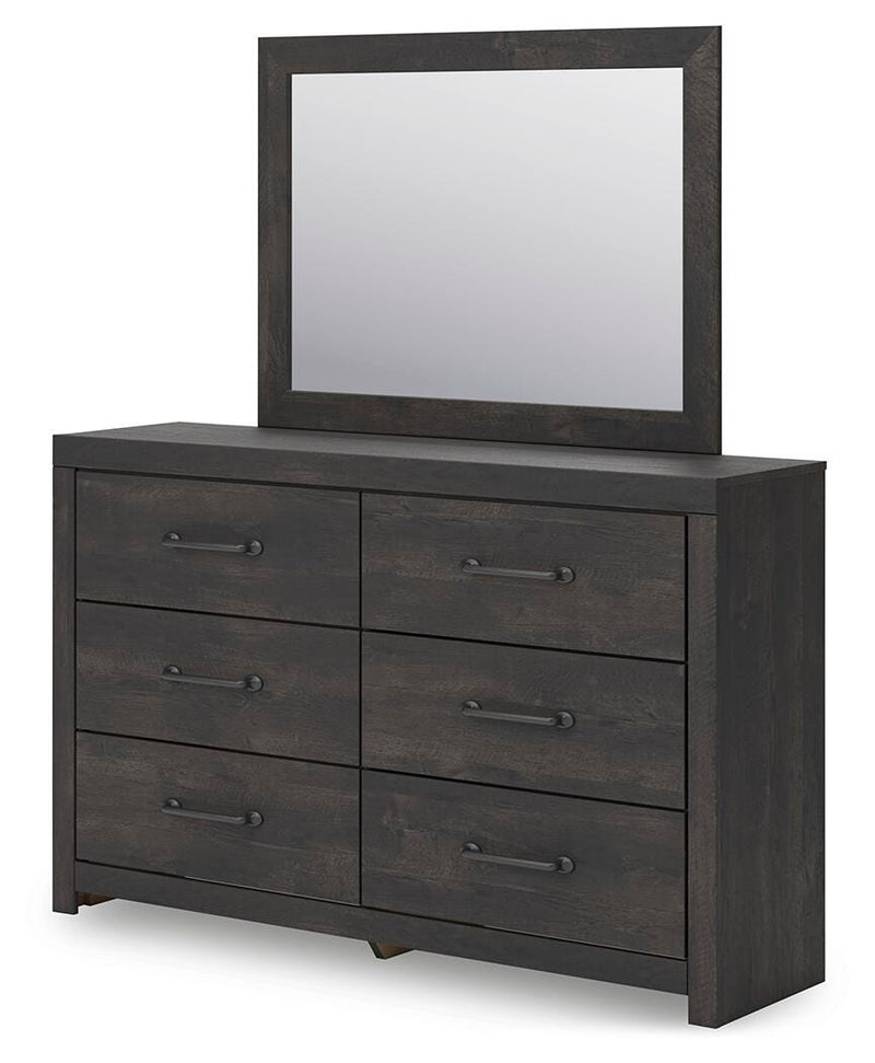 Ashley Furniture Hollivern bedroom set shown from an angle, featuring a bed with a wooden frame and matching nightstands.