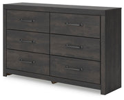 Ashley Furniture Hollivern dresser and mirror set shown from an angled side view, featuring a modern wooden dresser with a matching mirror.