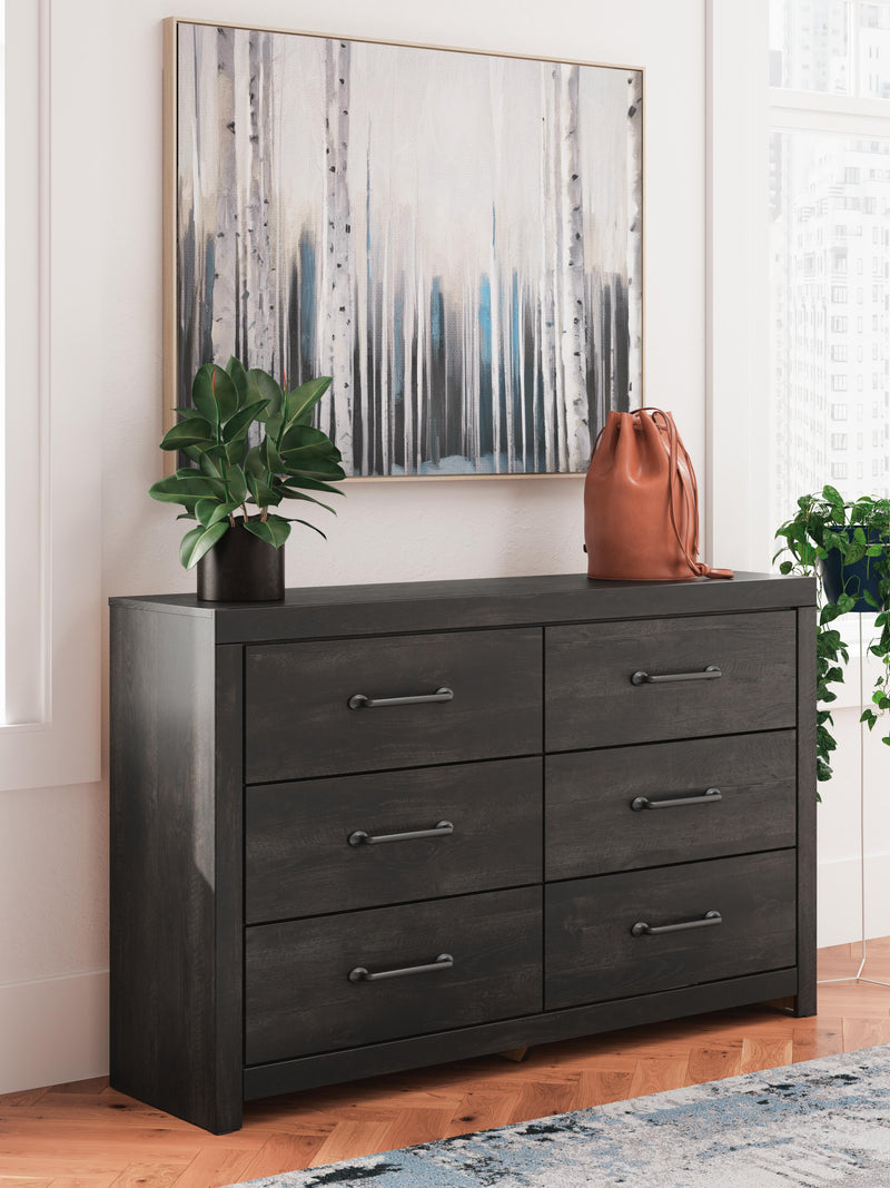Ashley Furniture Hollivern Dresser with multiple drawers and a dark wood finish, showcasing a modern bedroom storage solution.