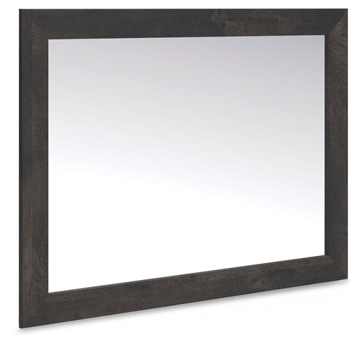 Ashley Furniture Hollivern bedroom mirror, angled view showing a sleek, modern mirror with a wooden frame.