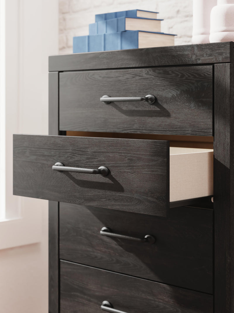 Close-up of Ashley Furniture Hollivern chest of drawers showing detailed wood finish and classic drawer handles.