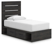 Ashley Furniture Hollivern Bed with a stylish upholstered headboard and wooden frame, shown from an angled side view.