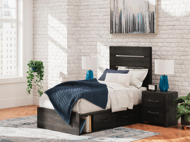Ashley Furniture Hollivern Bed with a stylish upholstered headboard and neutral-toned bedding in a cozy bedroom setting.
