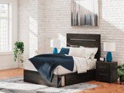 Ashley Furniture Hollivern Bed with upholstered headboard and wooden frame, shown in a stylish bedroom setting.