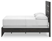 Ashley Furniture Hollivern Bedroom Set with a modern bed frame and matching nightstands, shown in a cozy bedroom setting.