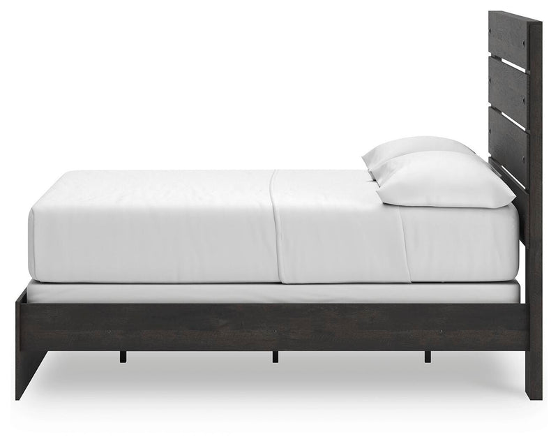 Ashley Furniture Hollivern bedroom set featuring a bed with a tufted headboard and coordinated nightstands in a modern design.