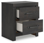 Ashley Furniture Hollivern bedroom set with a bed, nightstands, and dresser shown from an angled view in a modern bedroom.
