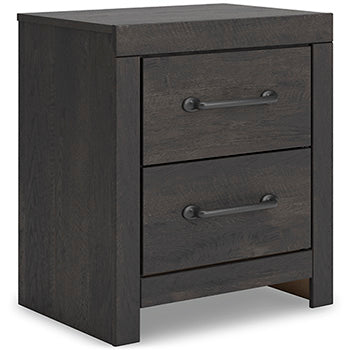 Ashley Furniture Hollivern bedroom set, angled view showing bed frame, headboard, and accompanying furniture pieces.