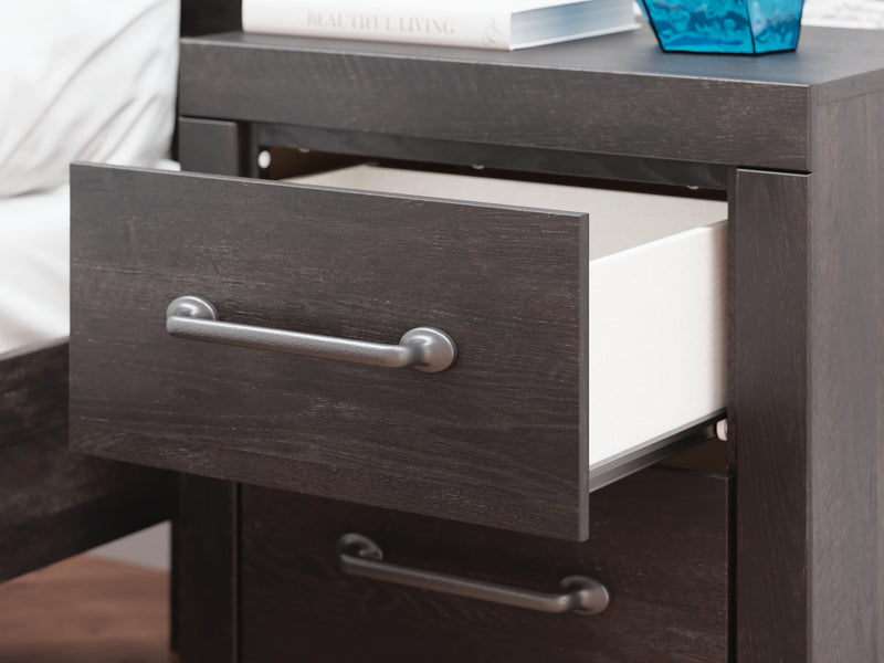 Close-up of the Ashley Furniture Hollivern Bedroom Set featuring detailed wood grain and elegant design elements.