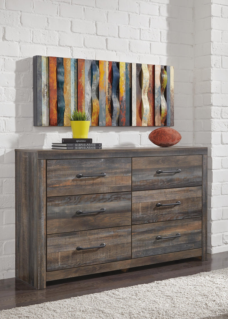 Ashley Furniture Drystan dresser with multiple drawers and a dark wood finish, shown in a modern bedroom setting.