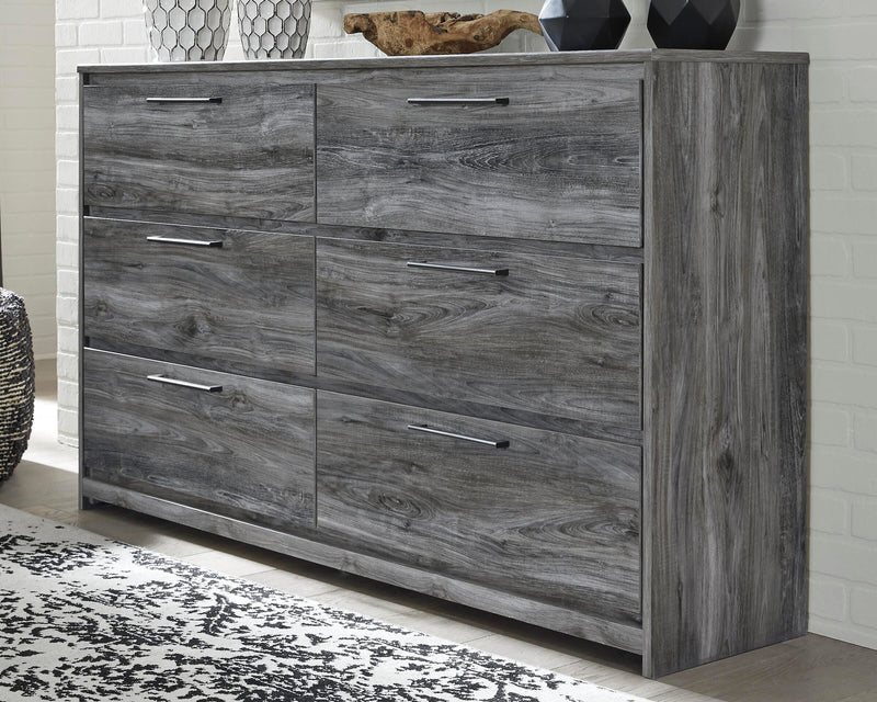 Ashley Furniture Baystorm dresser with sleek wood finish and multiple drawers, shown from a front view.