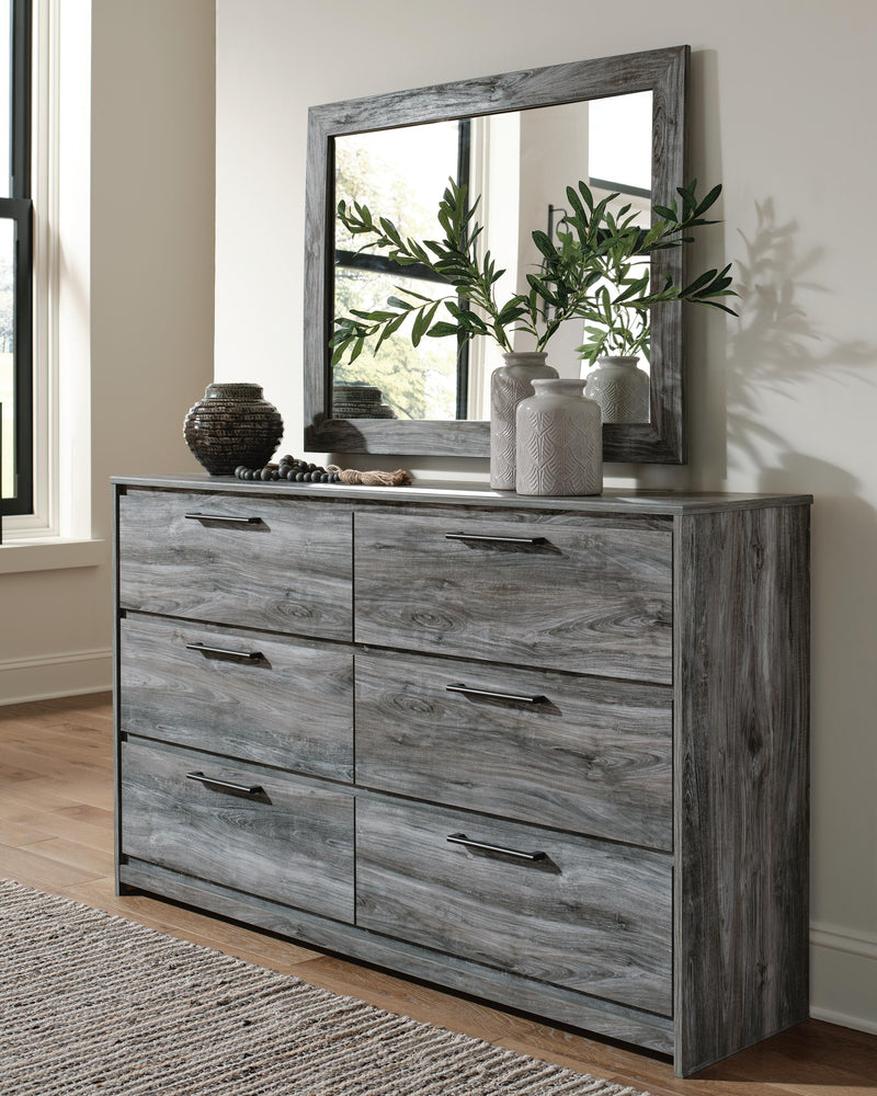Ashley Furniture Baystorm dresser with matching mirror, featuring a sleek wooden finish and modern design.