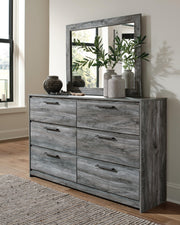 Ashley Furniture Baystorm dresser with attached mirror, showcasing a stylish wooden bedroom storage and mirror combo.