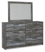 Ashley Furniture Baystorm dresser with matching mirror, showcasing a modern wooden bedroom furniture set in a well-lit room.