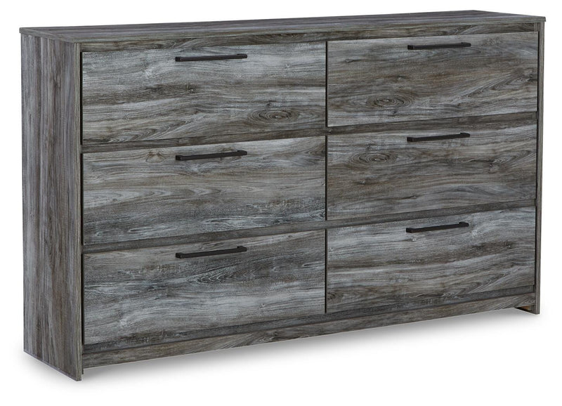 Ashley Furniture Baystorm dresser with multiple drawers and sleek wood finish, shown from an angled side view.