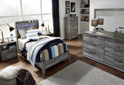 Ashley Furniture Baystorm Youth Bed with built-in storage drawers and a contemporary design in a warm wood finish.