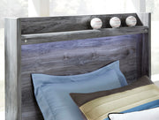 Ashley Furniture Baystorm storage bed with wooden finish, featuring built-in drawers and a sleek, modern design.