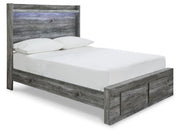 Ashley Furniture Baystorm Storage Bed with angled view, showcasing sleek wood finish and built-in storage drawers.
