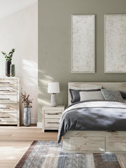 Ashley Furniture Lawroy Panel Storage Bed with sleek wood finish and built-in storage drawers in a modern bedroom setting.