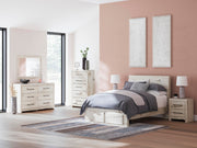 Ashley Furniture Lawroy panel storage bed with a sleek wooden design and built-in storage drawers in a modern bedroom setting.