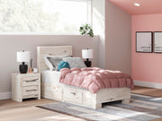 Ashley Furniture Lawroy Bed with a wooden frame and upholstered headboard, shown in a modern bedroom setting.