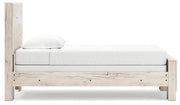 Ashley Furniture Lawroy Bed with beige upholstered headboard and wooden frame, shown from a side angle.