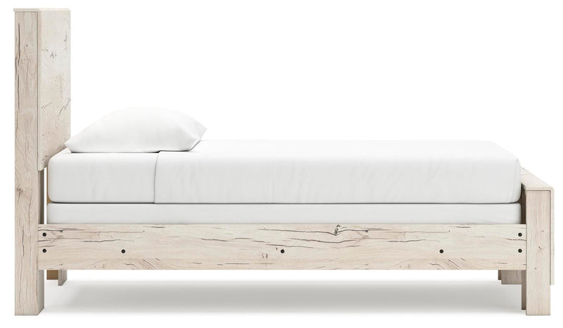 Ashley Furniture Lawroy Bed with beige upholstered headboard and wooden frame, shown from a side angle.