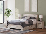 Ashley Furniture Lawroy Bed with a sleek, modern frame, showcasing a neutral-toned headboard and stylish bedding.