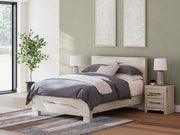 Ashley Furniture Lawroy Bed in a modern bedroom setting, showcasing a stylish wood bed frame with a sleek design.