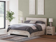 Ashley Furniture Lawroy Bed with upholstered headboard and wooden frame, shown in a modern bedroom setting.
