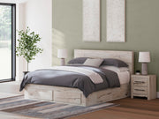 Ashley Furniture Lawroy Panel Storage Bed with wood finish and built-in storage drawers in a modern bedroom setting.