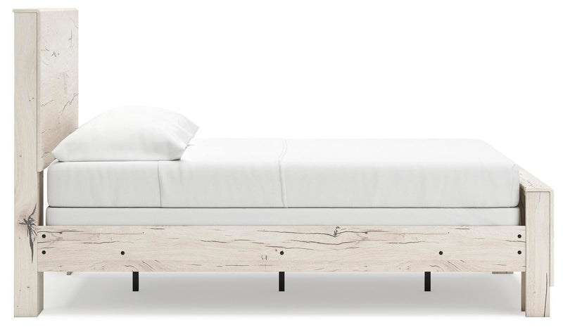 Ashley Furniture Lawroy Bed with wooden frame and headboard, shown from the side in a well-lit bedroom setting