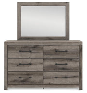 Graystorm bedroom set by Ashley Furniture, showing a modern bed with matching nightstands and a cozy, stylish bedroom arrangement.