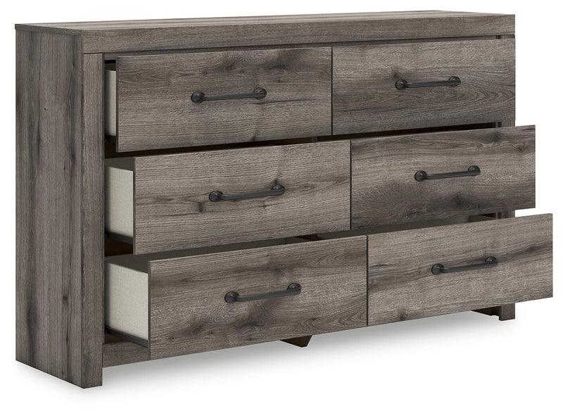 Ashley Furniture Graystorm dresser with open drawers, showcasing modern gray finish and spacious storage compartments.