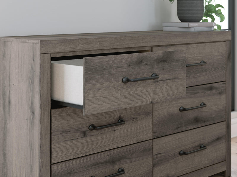 Graystorm dresser by Ashley Furniture featuring sleek gray finish, multiple drawers, and modern design details.