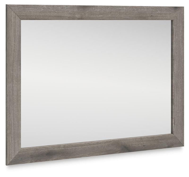 Graystorm bedroom mirror by Ashley Furniture, angled view showing a sleek, modern mirror with a gray finish.