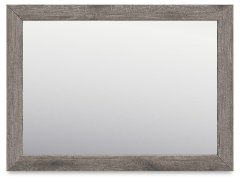 Graystorm dresser and mirror by Ashley Furniture, showing a modern gray dresser with a matching mirror in a contemporary bedroom setting.