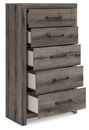 Open-angle view of Ashley Furniture Graystorm chest of drawers showing multiple drawers and sleek gray finish.