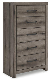 Graystorm chest of drawers by Ashley Furniture, angled view showing sleek gray finish and multiple storage drawers.