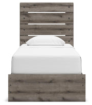 Graystorm Ashley Furniture storage bed with a headboard, showcasing clean lines and built-in storage drawers in a cozy bedroom setting.