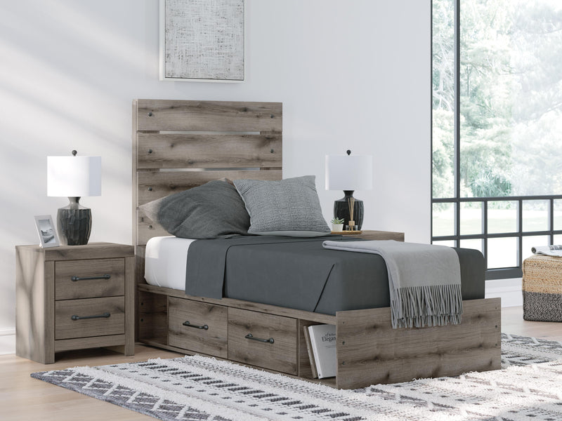 Graystorm Bed with Storage by Ashley Furniture, showcasing a modern gray bed frame with built-in storage drawers and sleek design.