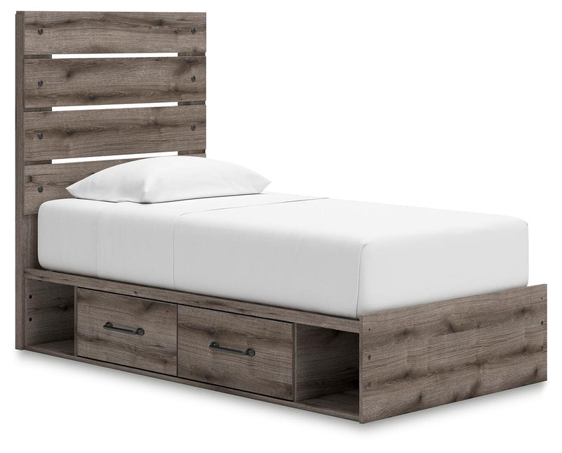 Graystorm Ashley Furniture storage bed with a gray upholstered headboard and built-in side drawers, angled view.