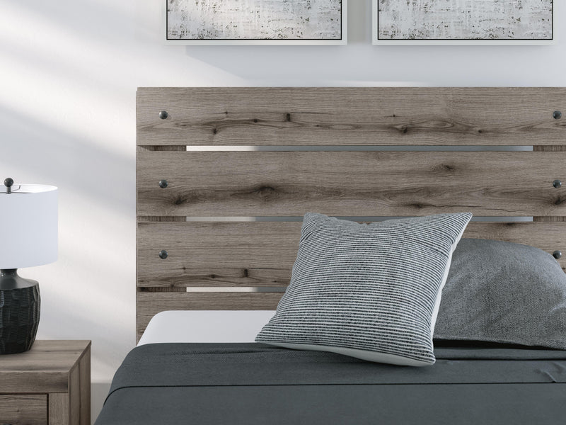 Graystorm bed with storage from Ashley Furniture, featuring a modern gray upholstered design and built-in storage drawers.