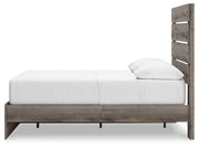Graystorm Bed with Storage by Ashley Furniture, showing a modern gray bed frame with built-in storage drawers underneath.