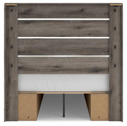 Graystorm storage bed by Ashley Furniture with a padded headboard and built-in drawers, shown from the back view.